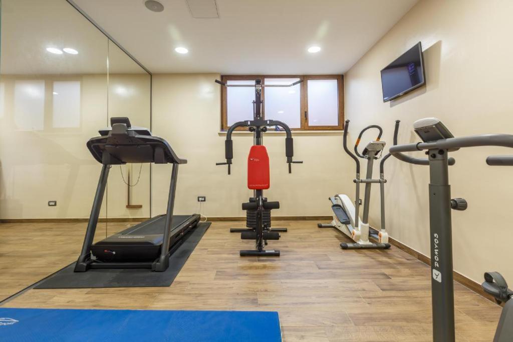 a gym with several cardio equipment in a room at Polidor Glamping Resort in Poreč