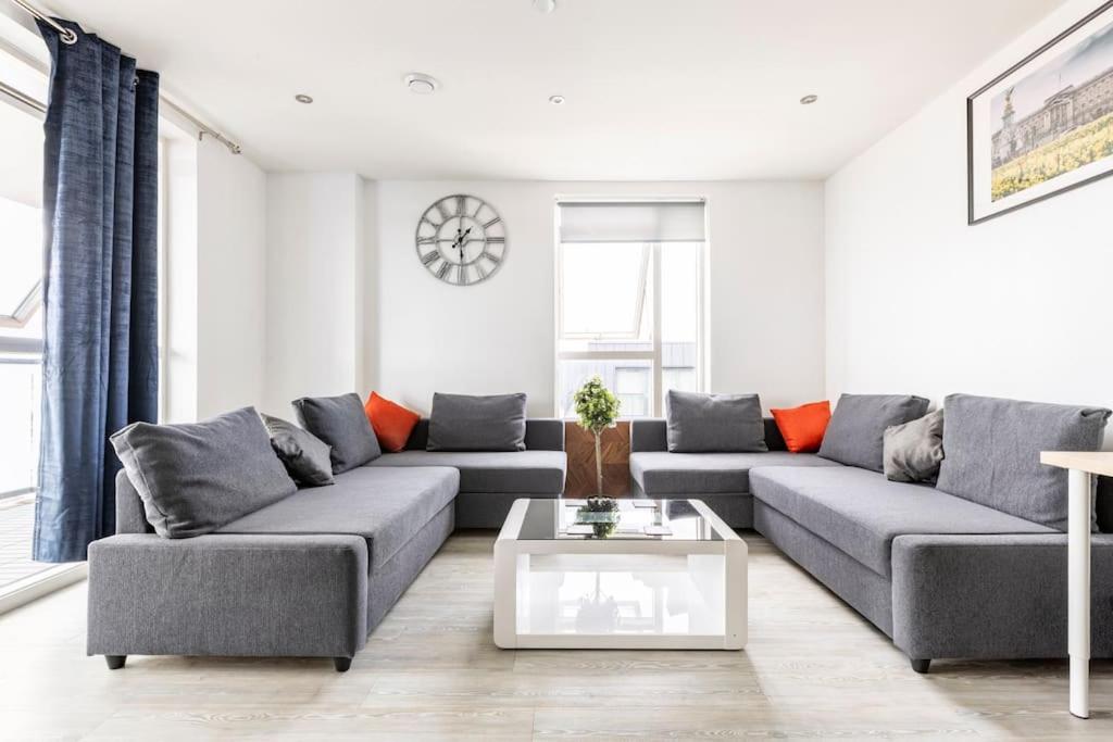 a living room with a couch and a table at Stylish & Comfortable Top-Floor Flat in Harrow in London