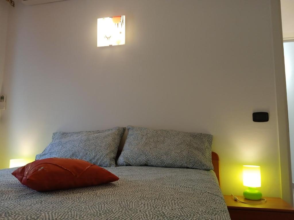 a bedroom with a bed with two lamps on it at VELA BLU in Ceriale