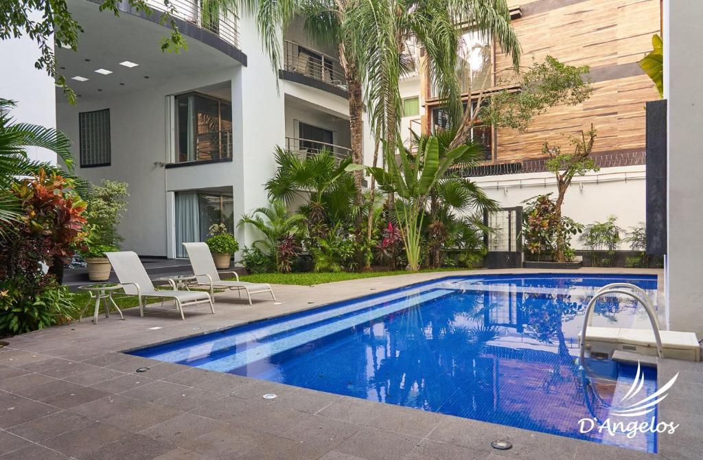 a swimming pool in front of a building at Almarea Vacation Condo in Playa del Carmen