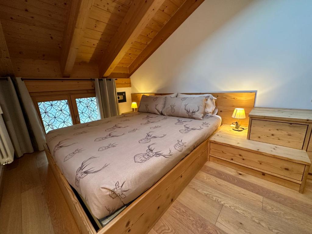 a bedroom with a large bed in a cabin at Alpine Escape in Bormio
