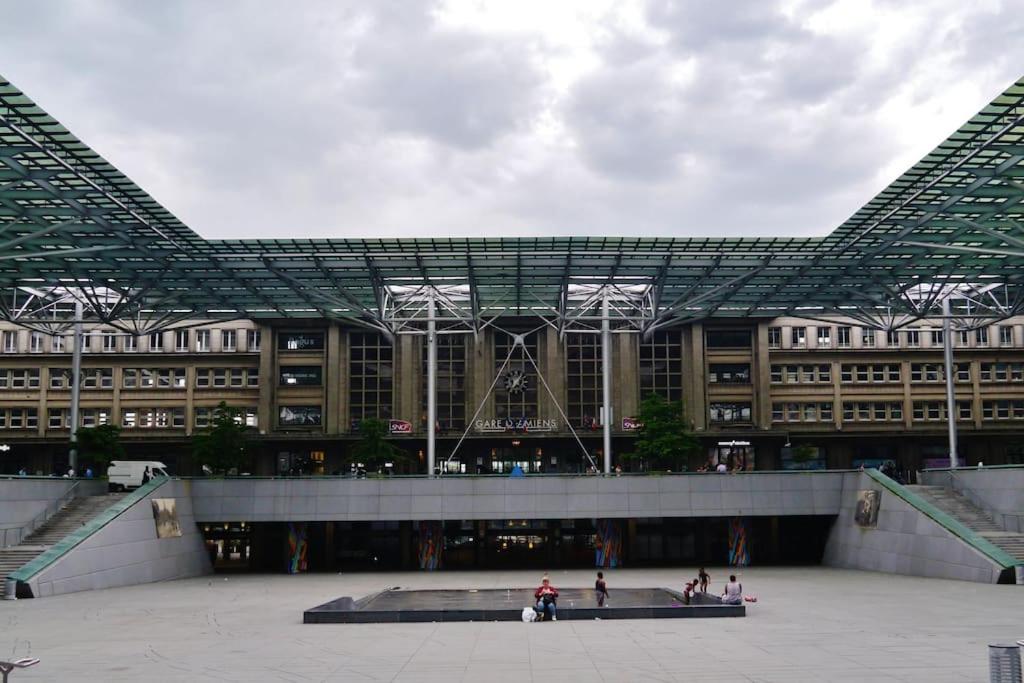 a large building with people standing in front of it at Appartement neuf entièrement équipé proche centre in Amiens