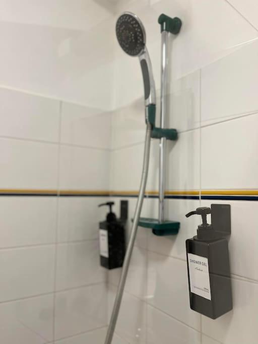 a bathroom with a shower and a blow dryer at Appartement neuf entièrement équipé proche centre in Amiens