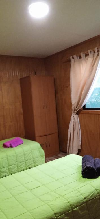 Letto o letti in una camera di Cabañas & Hostal Tojika