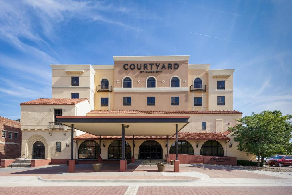 a large building with a sign on it at Courtyard by Marriott Wichita at Old Town in Wichita