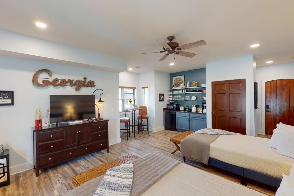 a bedroom with a bed and a flat screen tv at Abruzzi - Villa B in Eatonton 