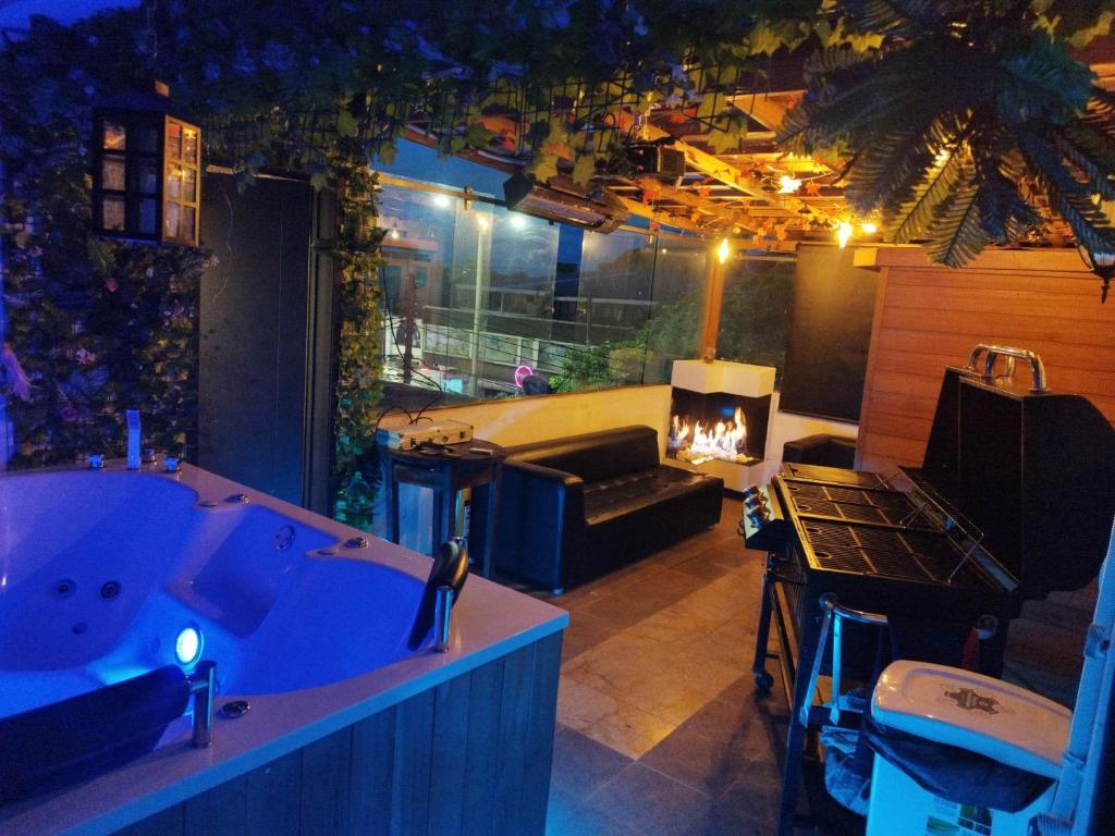 a room with a bath tub and a fireplace at Apartamento Penthouse con Jacuzzi y Chimenea in Bogotá