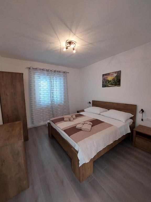 a bedroom with a large bed and a window at Family Room Drace 4550a in Drače