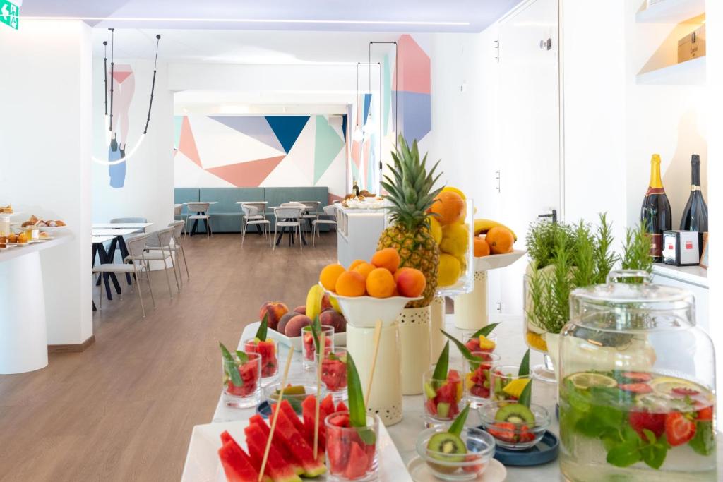 a table filled with fruits and vegetables in a room at Amarina Hotel in Marina di Pietrasanta