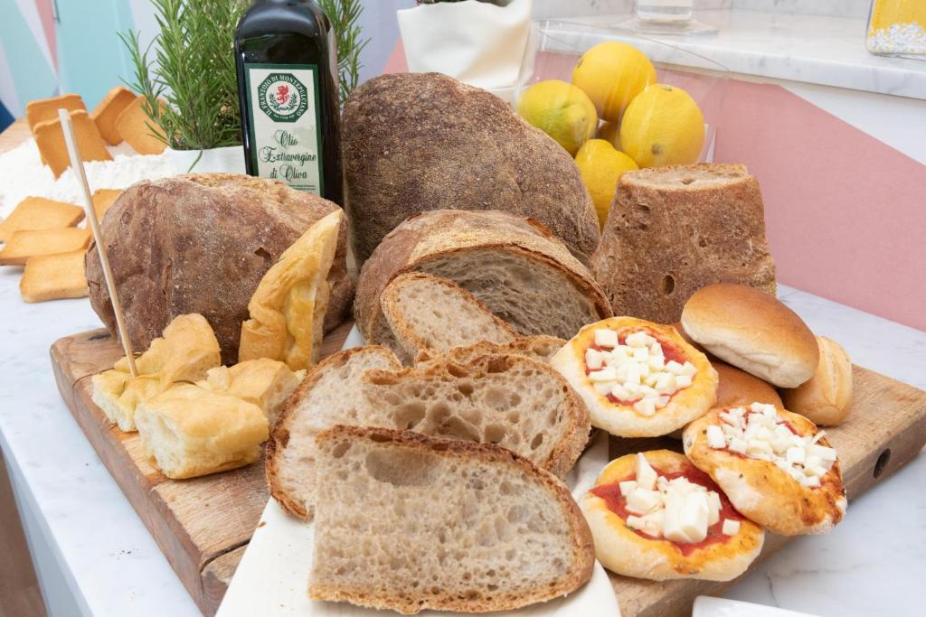 a group of breads and other foods on a table at Amarina Hotel in Marina di Pietrasanta