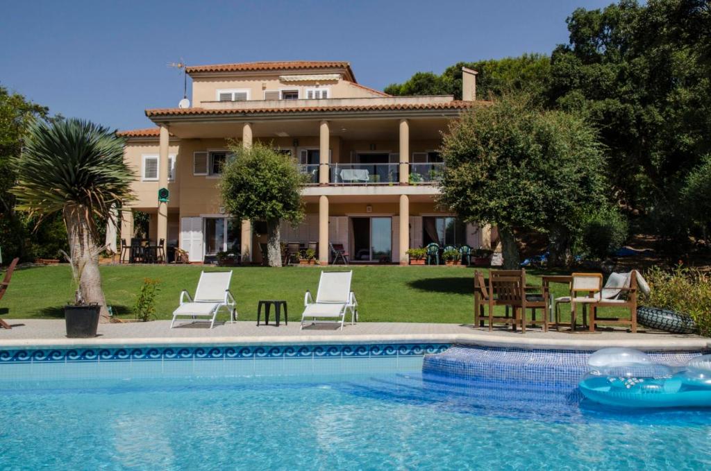 a house with a swimming pool in front of a house at Sotogrande. Estancia privada en plena naturaleza in Sotogrande