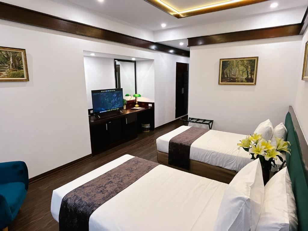 Postel nebo postele na pokoji v ubytování Mango Hotel - Ha Noi Railway station