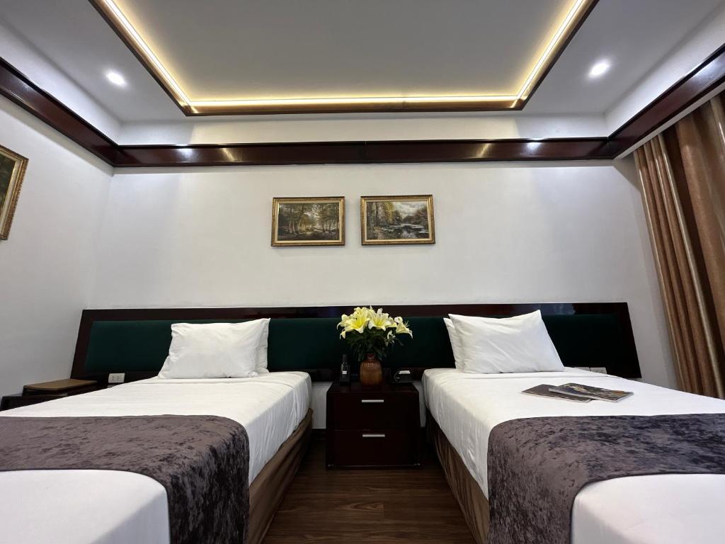 Postel nebo postele na pokoji v ubytování Mango Hotel - Ha Noi Railway station