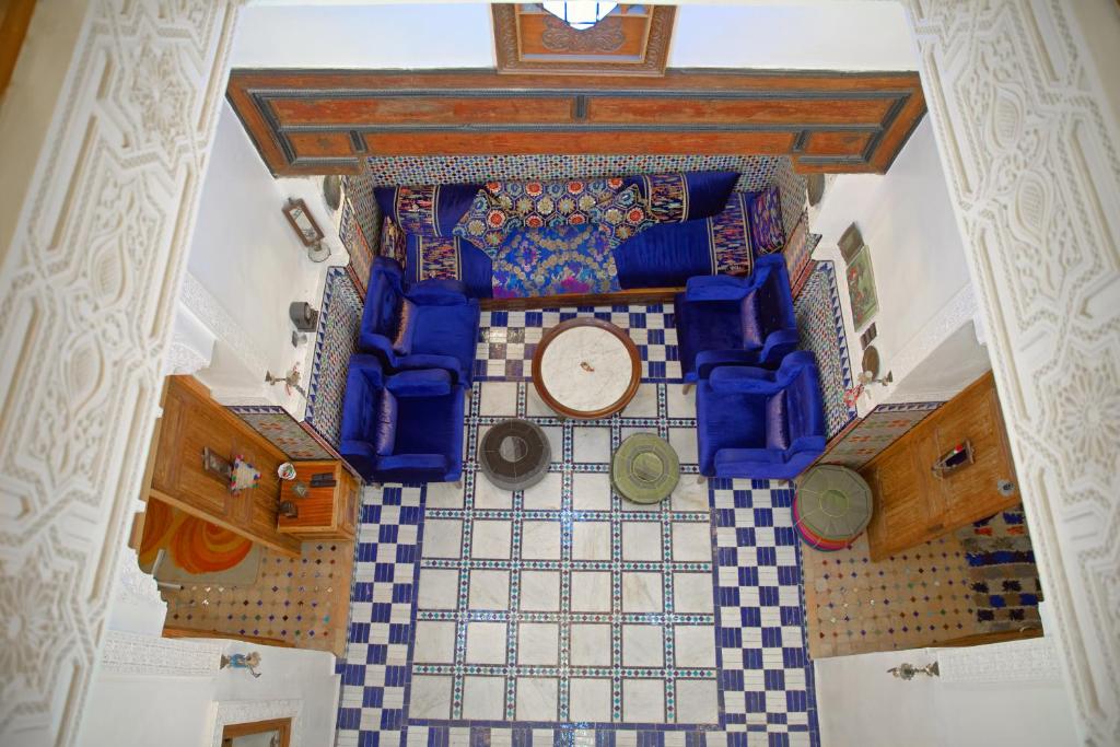 an overhead view of a tile floor with a clock on it at Dar Noursinn Fez in Fès