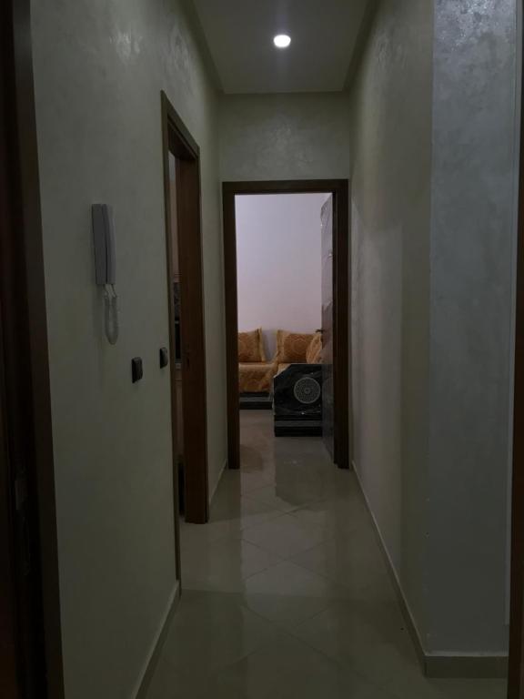 a hallway with a door and a room with a couch at Spacious 2-rooms apartment in Martil