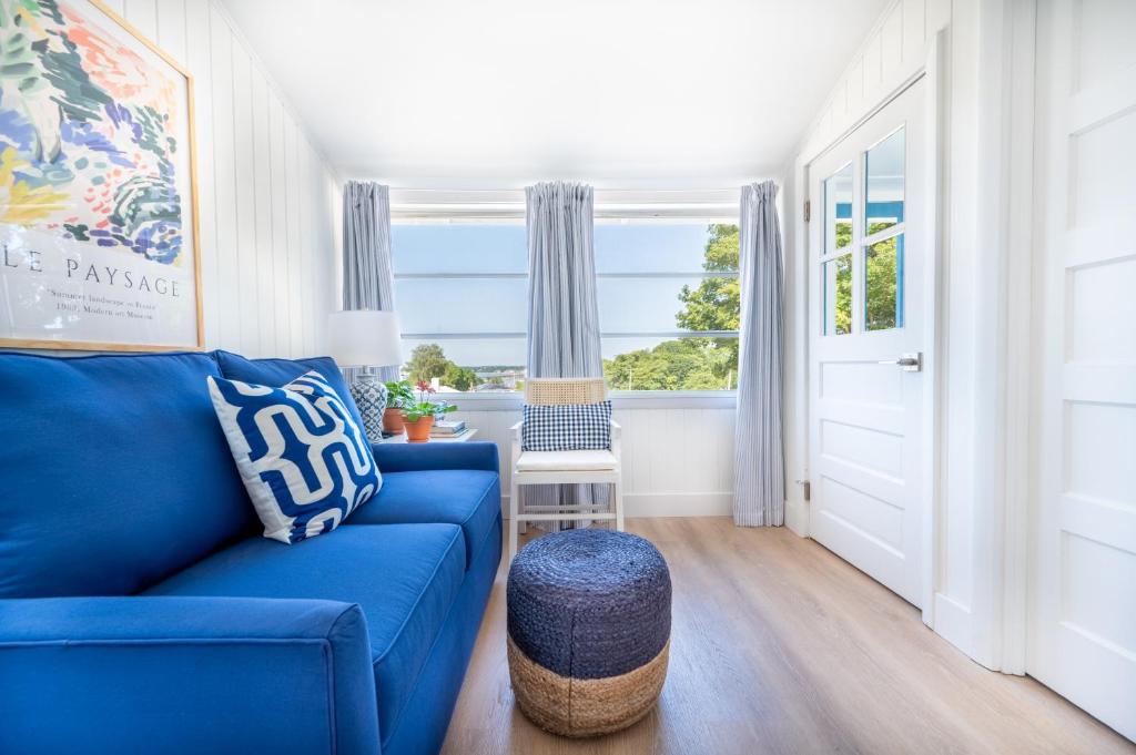 a living room with a blue couch and a window at Marina Bay Cottages in Waterford