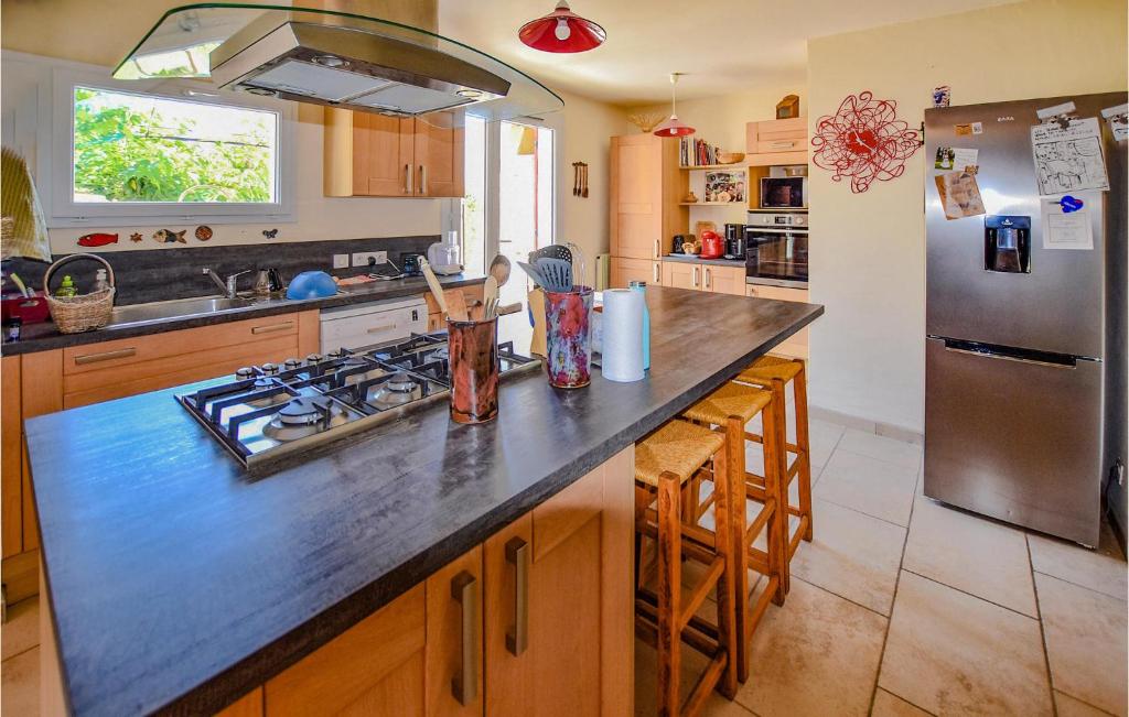 a kitchen with a counter top and a refrigerator at Nice Home In Taulignan With Wifi in Taulignan