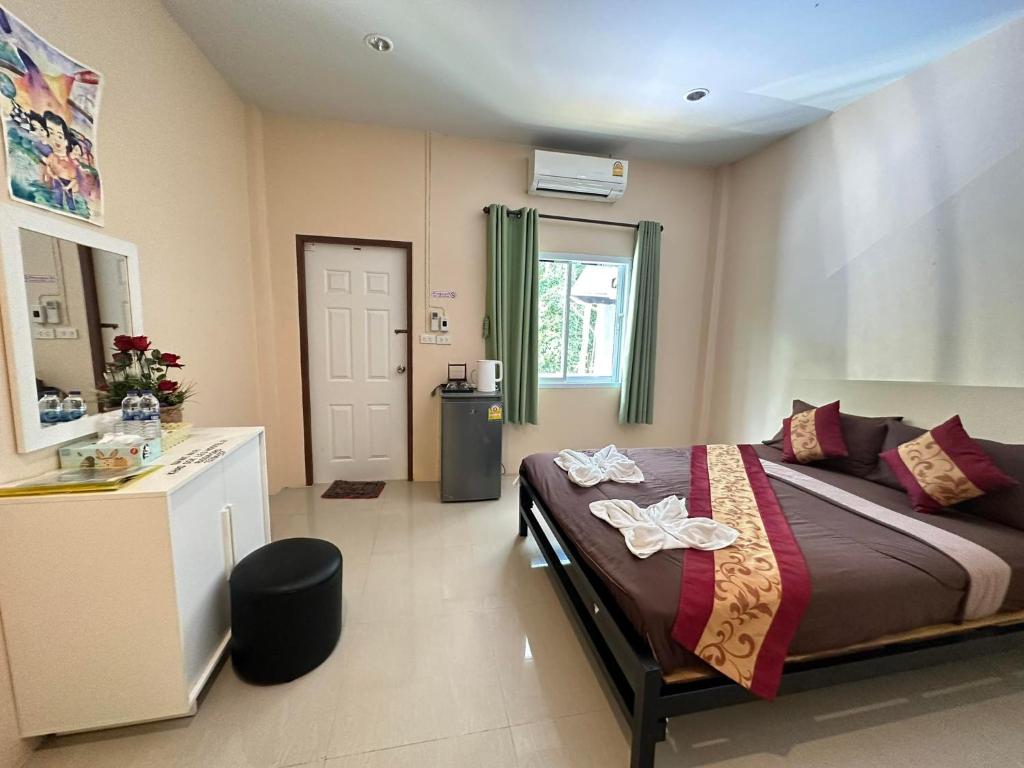 una camera con letto, lavandino e finestra di Painting Family Hostel a Parco Nazionale di Khao Sok