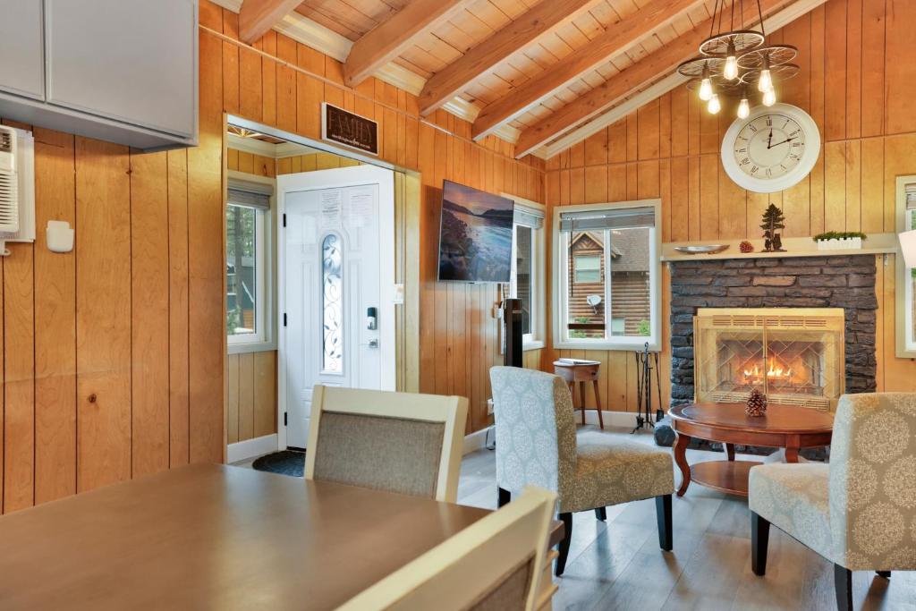 a dining room with a fireplace and a table and chairs at Sweet Retreat 1- Cozy Relaxing Resort Cabin in Big Bear Lake