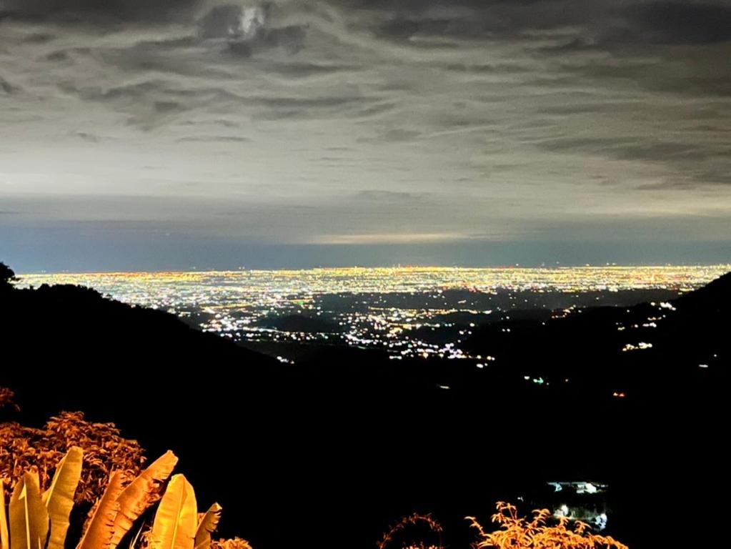 a view of a city at night from a mountain at Zhong Ming Ju Taoyi Fang in Fanlu
