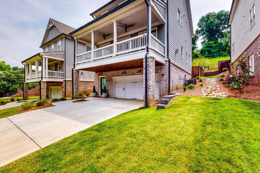 a large house with a garage and a grass yard at In the Heart of the City in Marietta