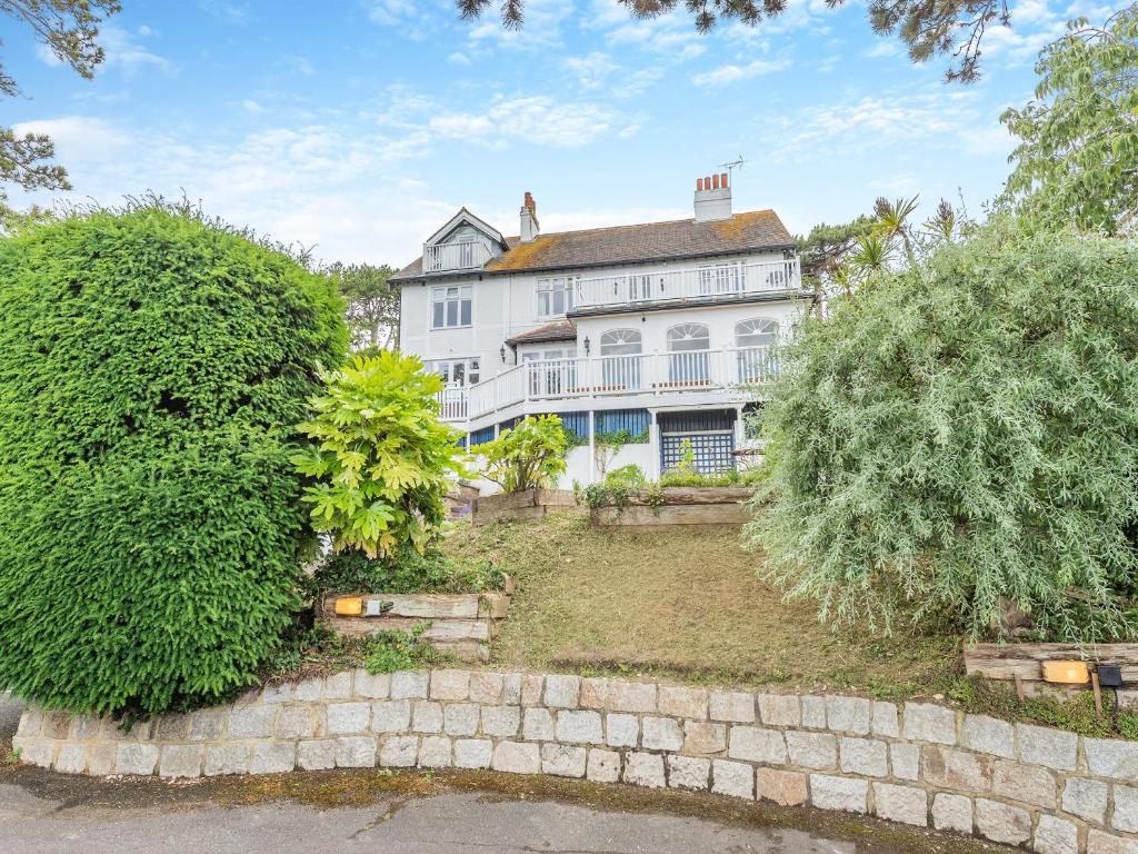 a large white house with a stone wall at The Cottage in St Margarets at Cliff