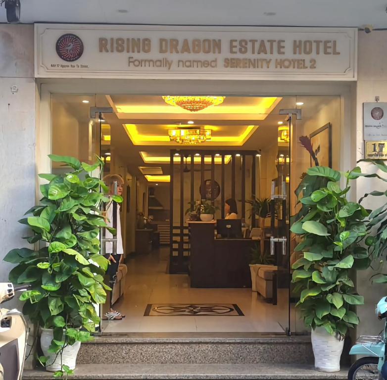 a lobby of a hotel with a sign that reads rising dragon estate hotel at Rising Dragon Hotel in Hanoi