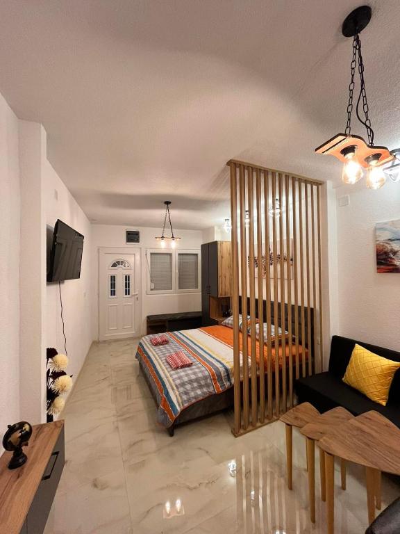 a bedroom with a bed with a crib in it at Apartman Lile Raca in Ohrid