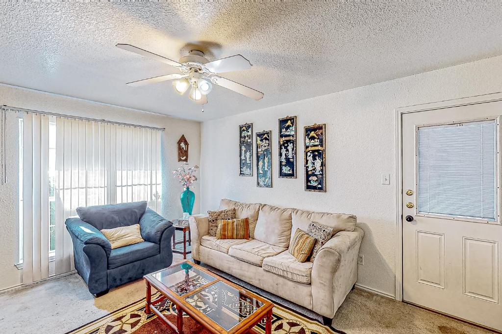 a living room with a couch and two chairs at Brickside Beauty in Killeen