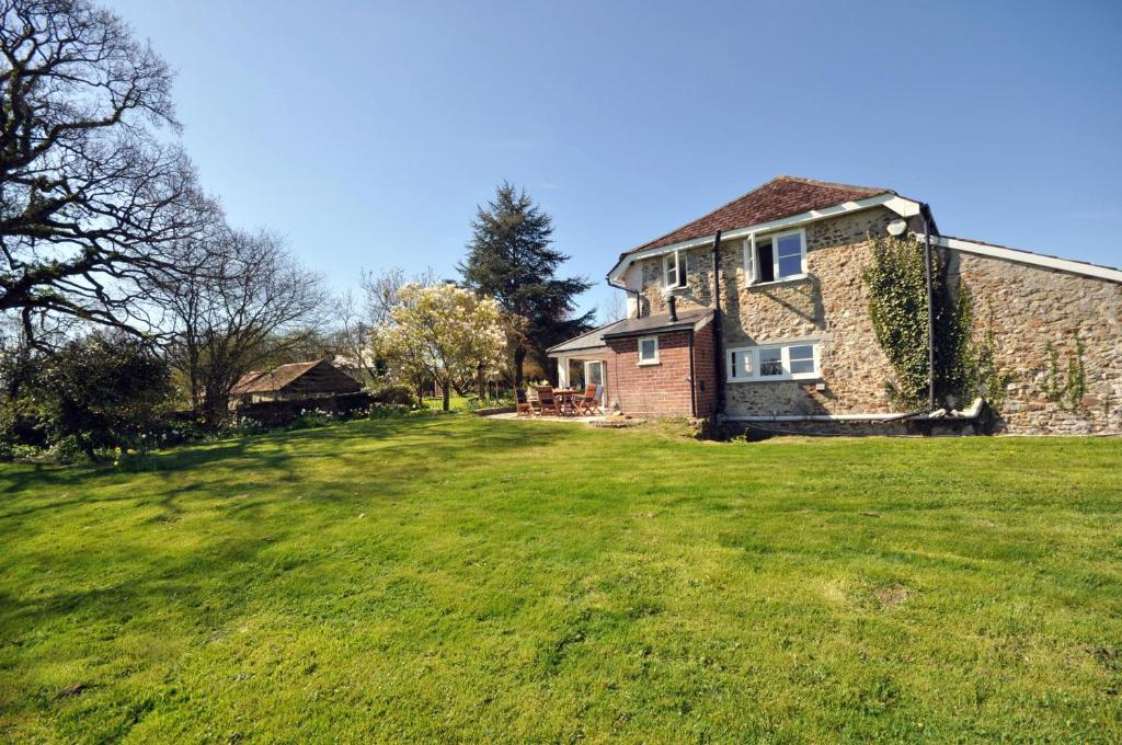 an old brick house in a grassy field at Culverwells in Axminster