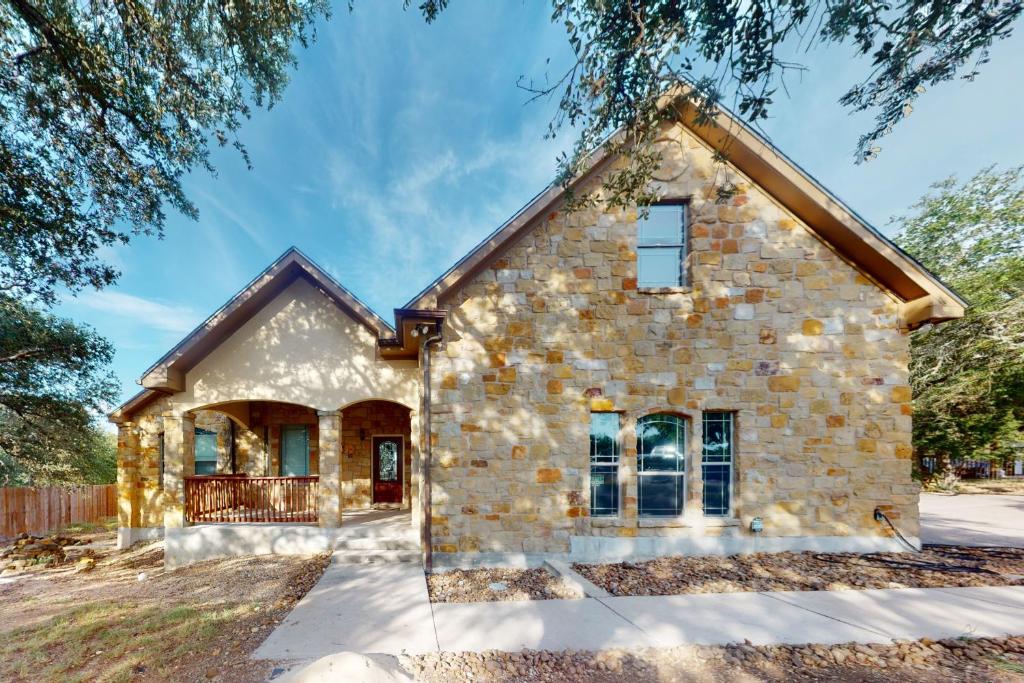 a stone house with a brick facade at Captivating Cottage in New Braunfels