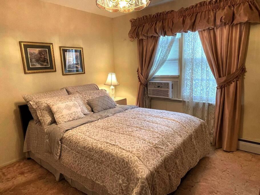 1 dormitorio con cama y ventana en Entire Home in Buffalo - 6 Guests 3 Bedroom 1 Bath - Convenient Location 7 mins from Airport en Buffalo