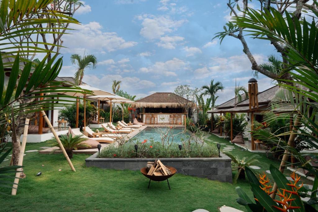 a resort yard with a pool and a house at EHOA BALI Nyanyi Boutique Hotel - In front of entrance to NUANU in Tanah Lot