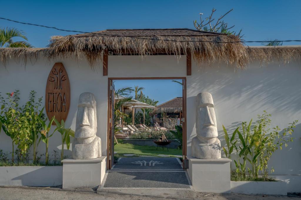an entrance to a resort with a thatch roof at EHOA BALI Nyanyi Boutique Hotel - In front of entrance to NUANU in Tanah Lot