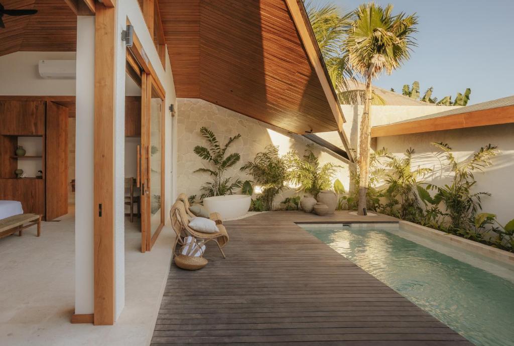 a house with a swimming pool in the middle of a yard at Sage Villas Bingin in Uluwatu