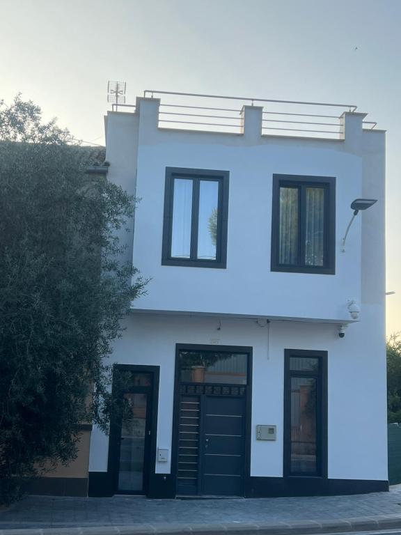 a white house with black doors and windows at Luxury Holiday House in Valencia