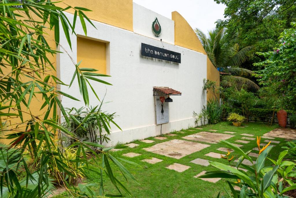 a building with a sign on the side of it at The Banyan Soul in Anjuna