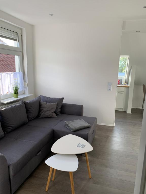 a living room with a couch and a table at Villa Mariensiel II in Sande