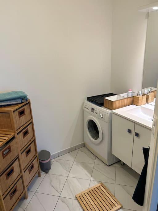 a kitchen with a washing machine in the corner at L’appartement du bonheur in Colombes