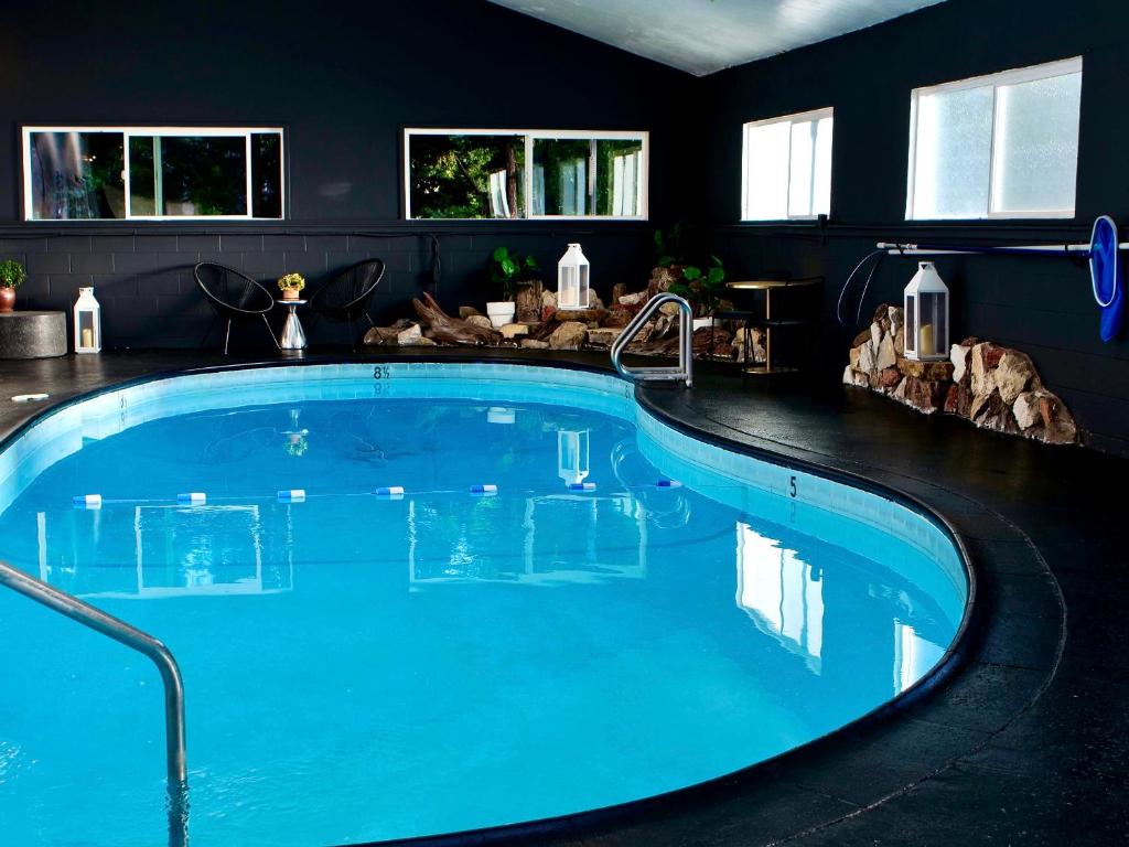 a large swimming pool in a room with blue water at Sierra Blue Hotel & Swim Club in Big Bear Lake