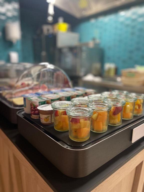 a buffet line with jars of food on a counter at Hôtel Restaurant BO &amp; MIA in La Baule