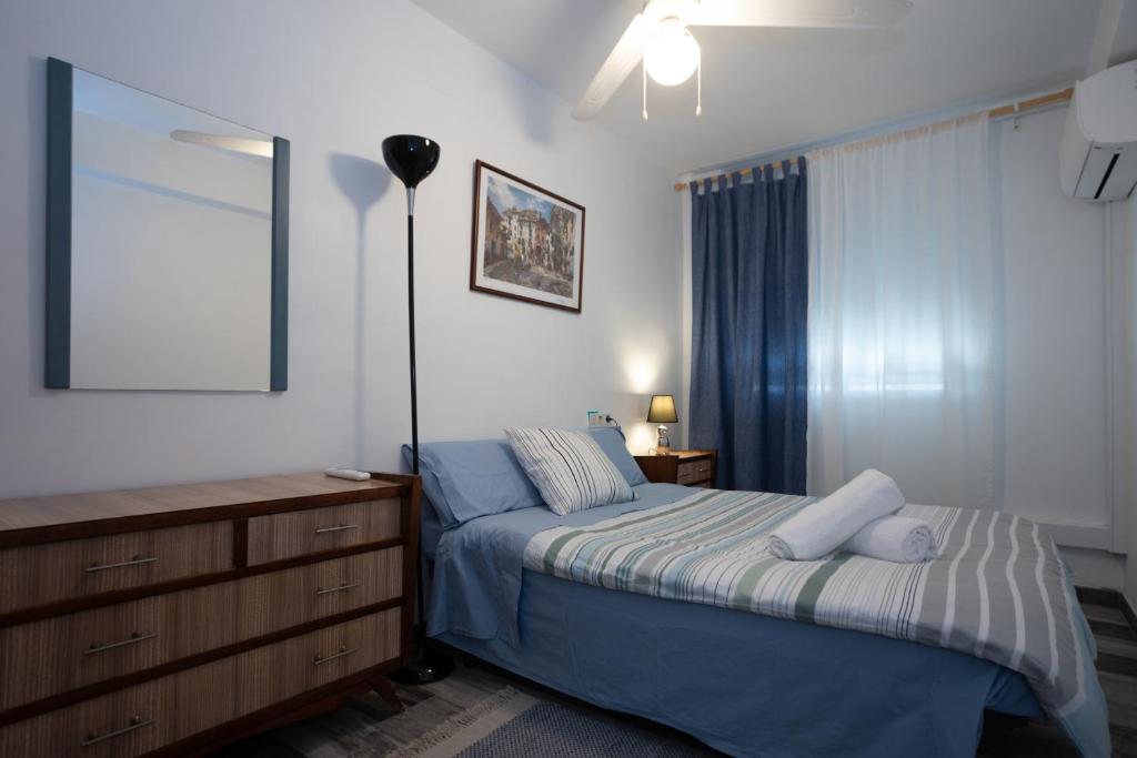 a bedroom with a bed and a dresser and a mirror at Altea Mar y Puerto in Altea