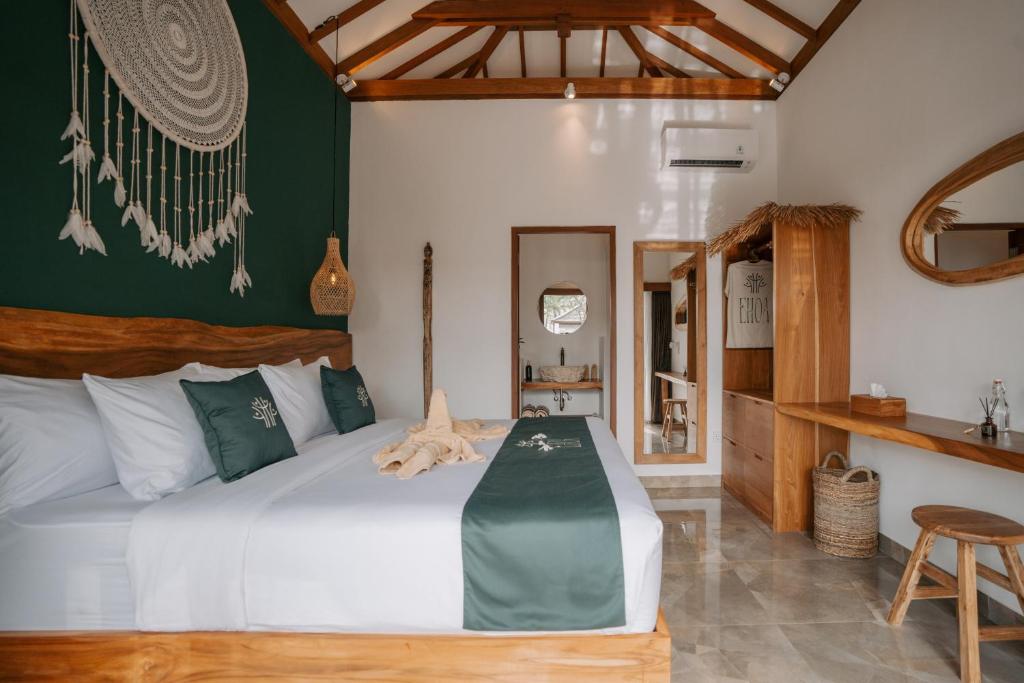 a bedroom with a bed with a green wall at EHOA BALI Nyanyi Boutique Hotel - In front of entrance to NUANU in Tanah Lot