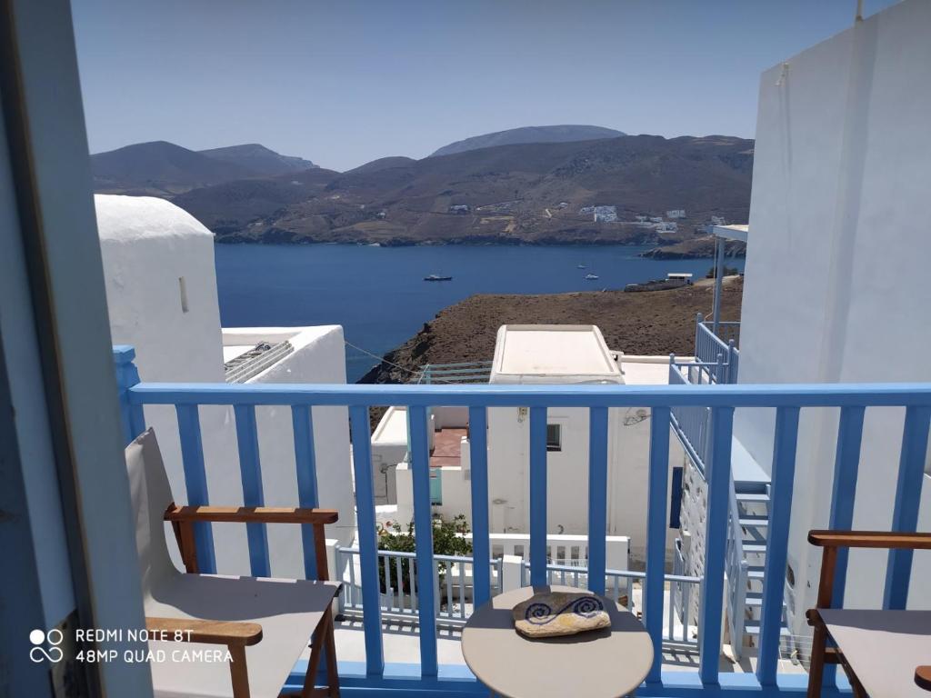 a balcony with chairs and a view of the water at Aiolos TRADITIONAL HOUSE IN ASTYPALAIA in Astypalaia