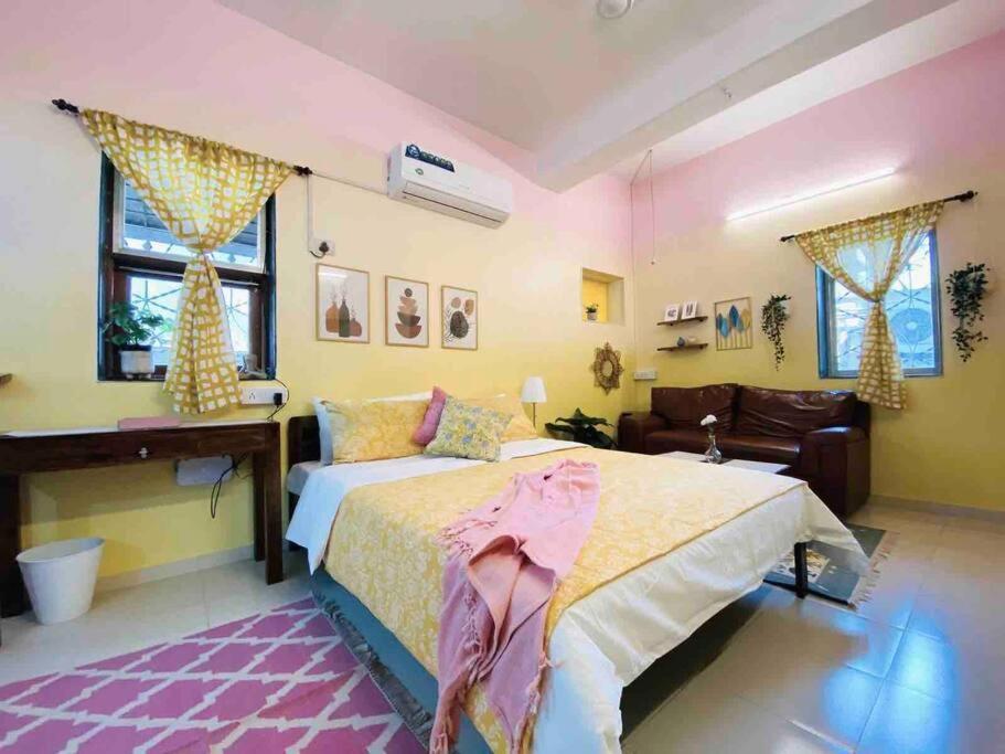 a large bedroom with a bed and a couch at Bandra Studio Lokhandwala House, Near Carter Road, Palli Hill by Connekt Homes in Mumbai