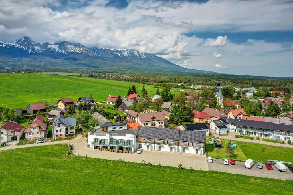 an aerial view of a small town with mountains at Penzión Čerešňový Sad & Wellness in Mengusovce
