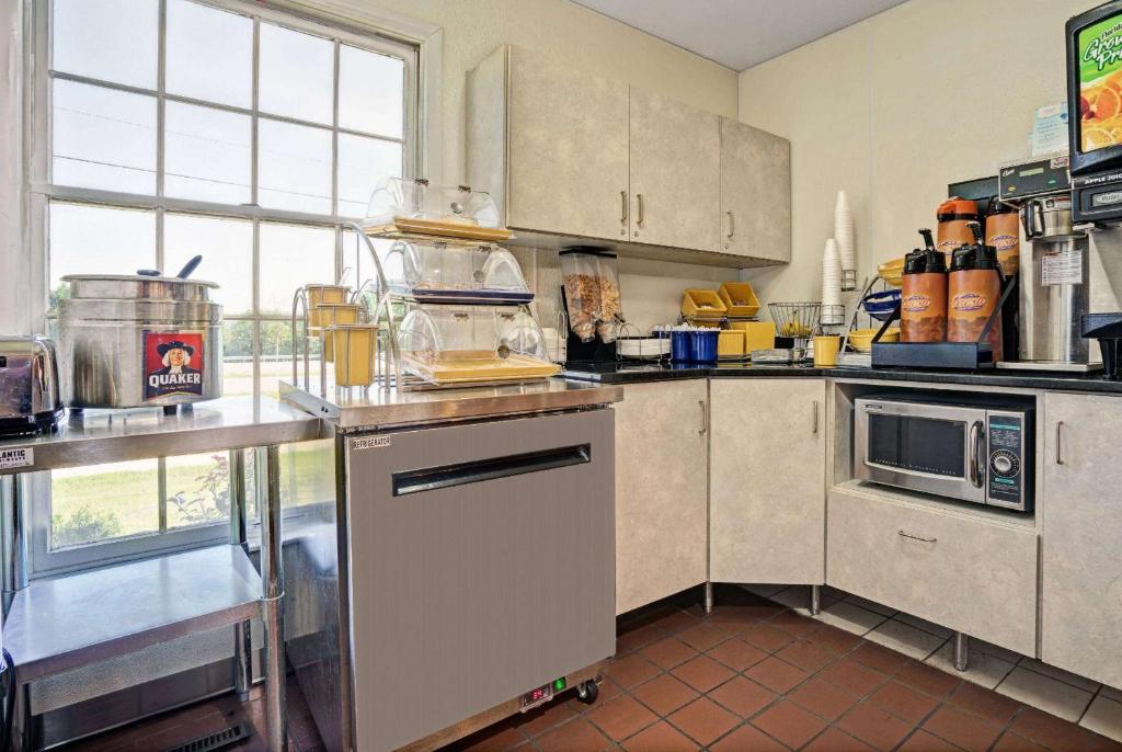 a kitchen with stainless steel appliances and a window at Travelodge by Wyndham Red Wing in Red Wing