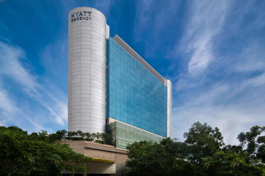 a tall white building with a sign on it at Hyatt Regency Chennai in Chennai