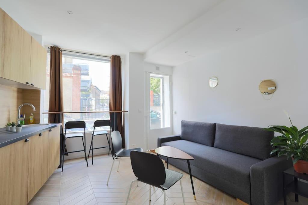 un salon avec un canapé et une cuisine dans l'établissement Très beau T3 proche RER Port Royal 6 pers, à Paris