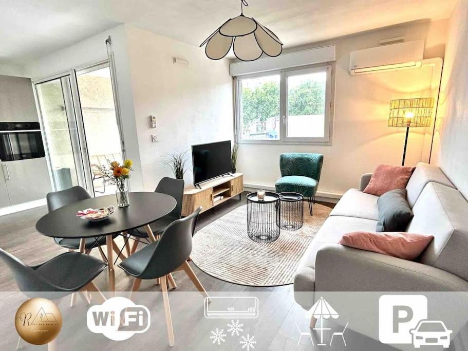 een woonkamer met een bank en een tafel bij T1bis avec terrasse et parking privés LE MIAMI in Perpignan